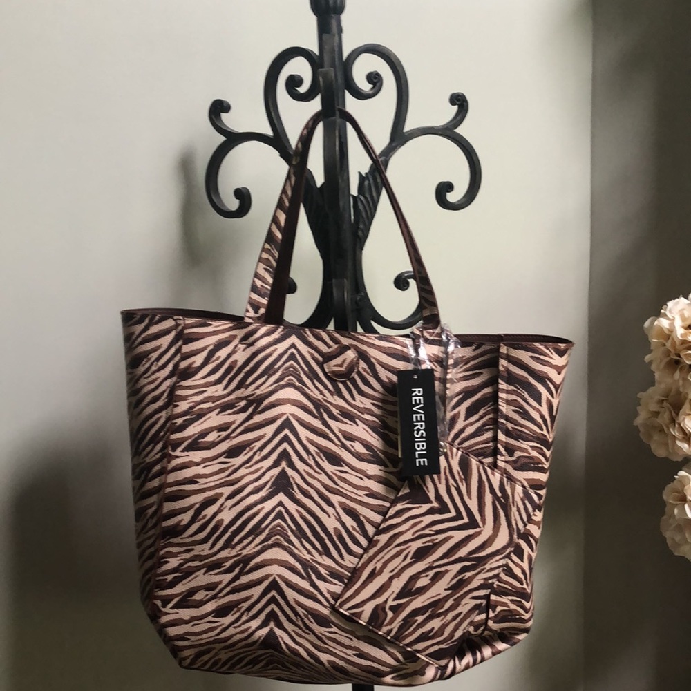Reversible animal print/chocolate tote bag with magnetic closure.